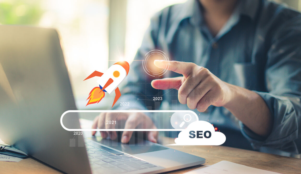 Marketer using a laptop to analyze SEO performance and if their website follows Google E-E-A-T guidelines