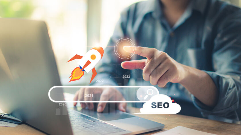 Marketer using a laptop to analyze SEO performance and if their website follows Google E-E-A-T guidelines