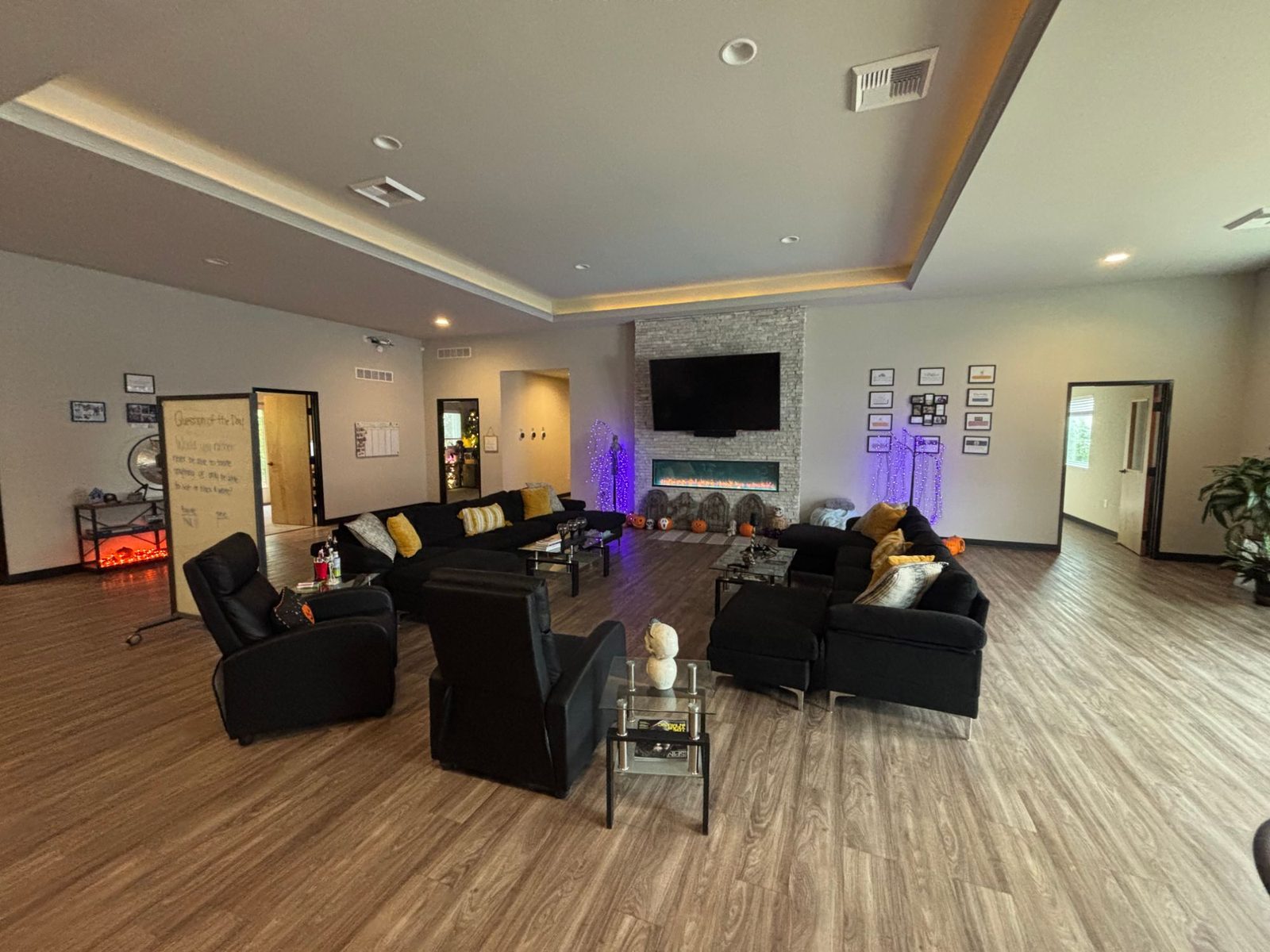 Lounge with sectional sofas, recliners, and a fireplace at the Relevance office