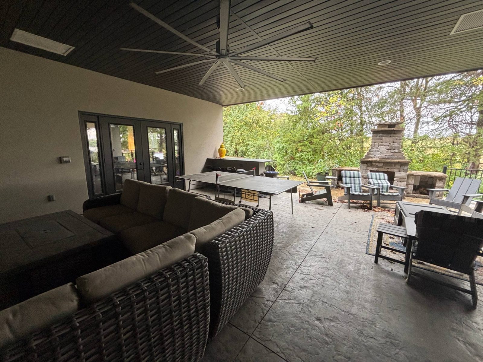 Ping pong table on the covered patio at the Relevance office, with an outdoor stone fireplace